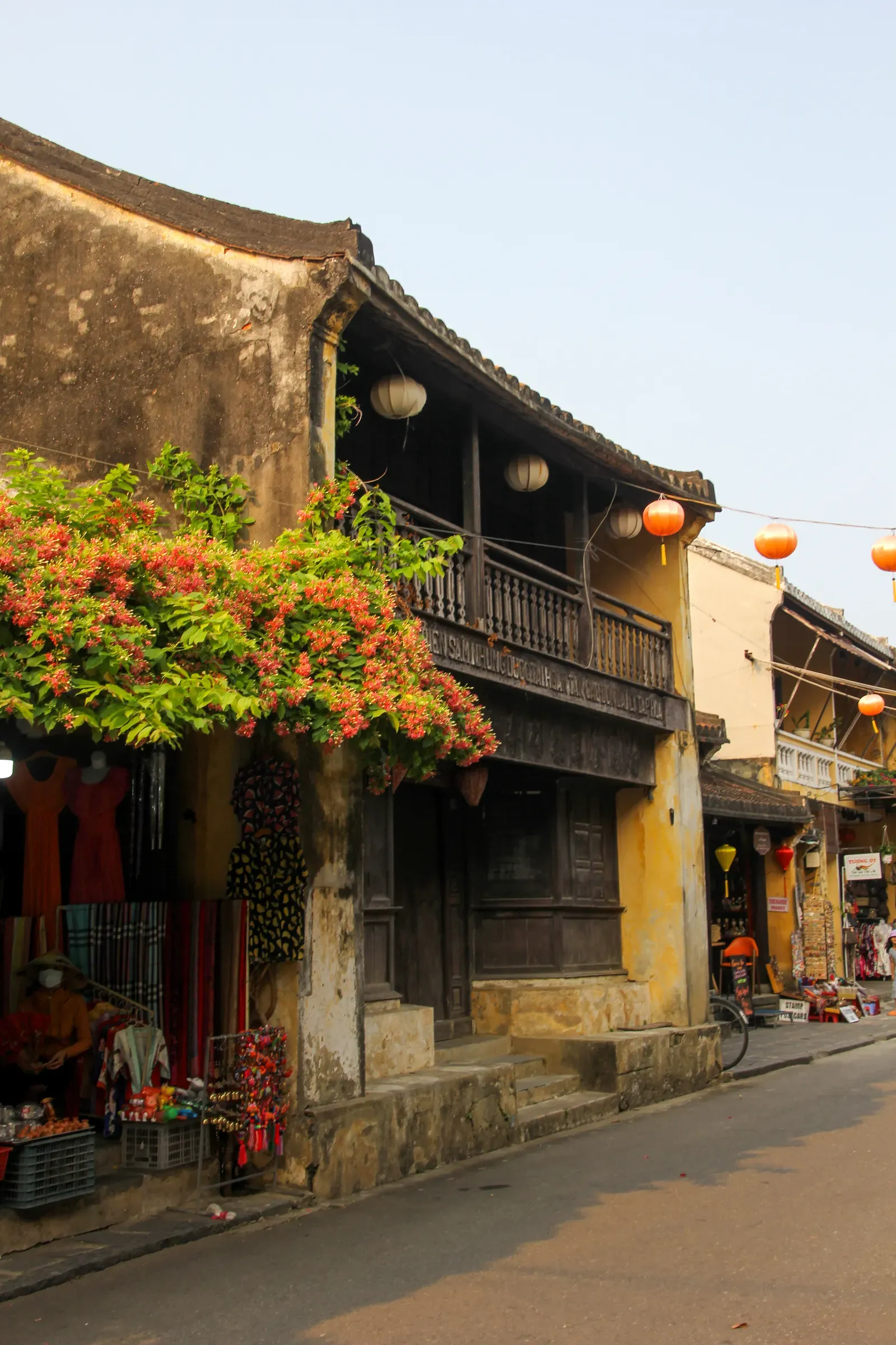 Lanterns and yellow heritage buildings on a Hoi An street