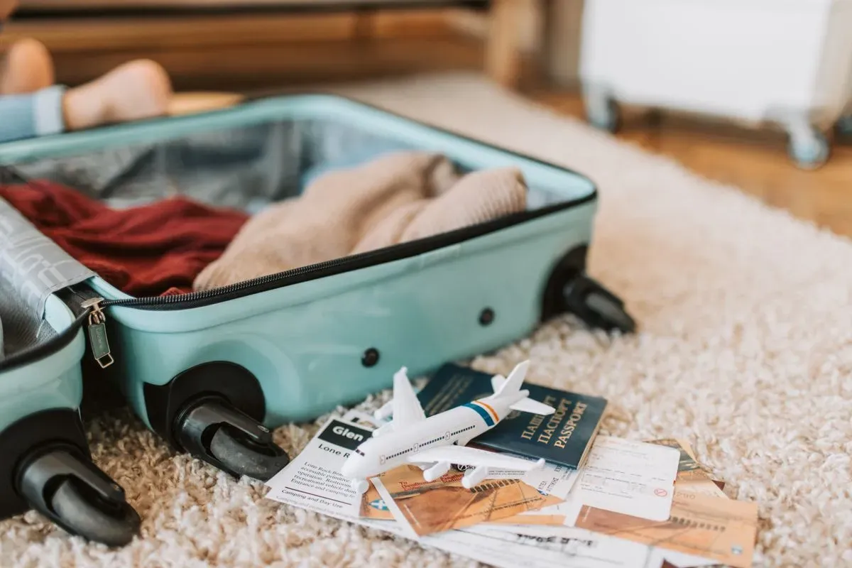 An open suitcase with travel documents ready for packing