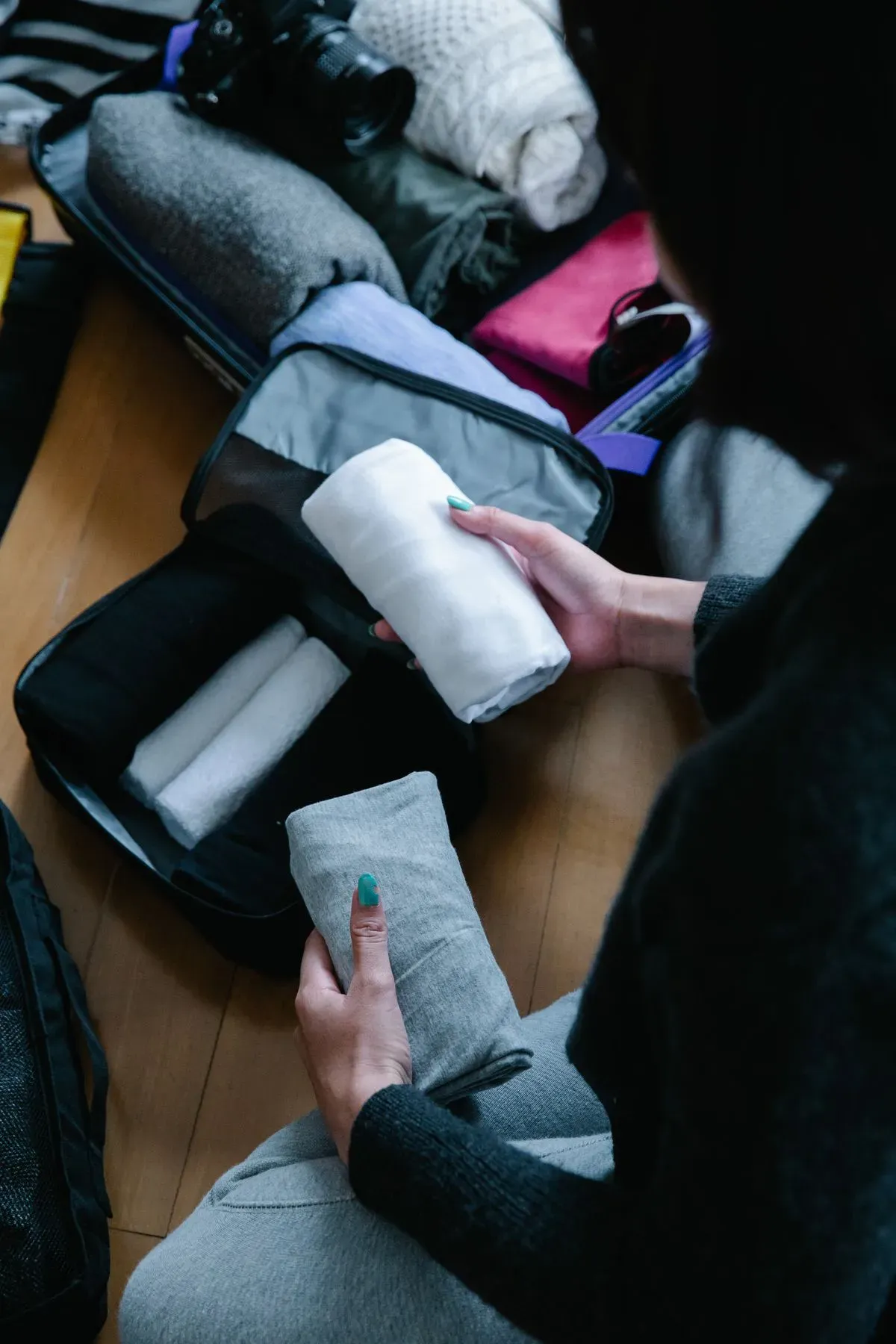 Folded clothes being packed for a trip