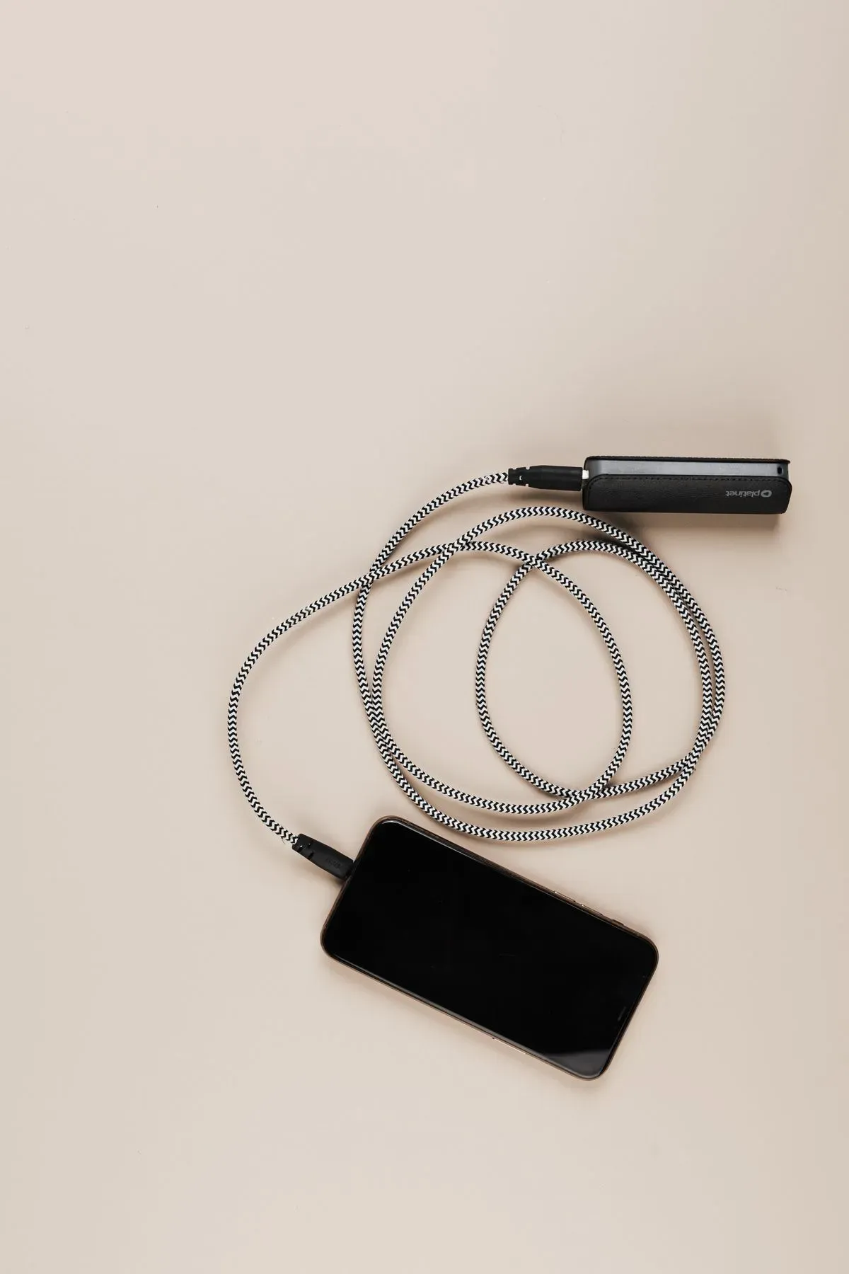 A smartphone connected to a portable power bank