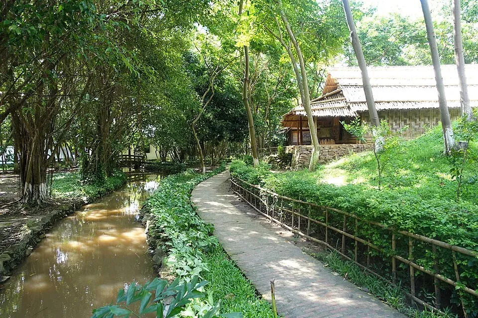 Shaded path and traditional building in the Vietnam Museum of Ethnology architecture garden